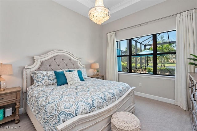 carpeted bedroom with an inviting chandelier and baseboards