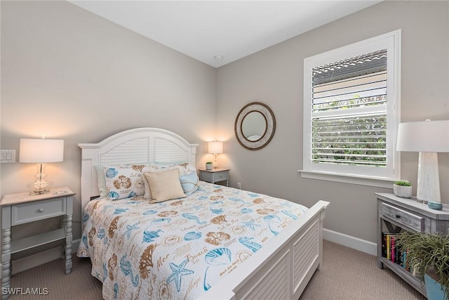 bedroom featuring baseboards and light colored carpet