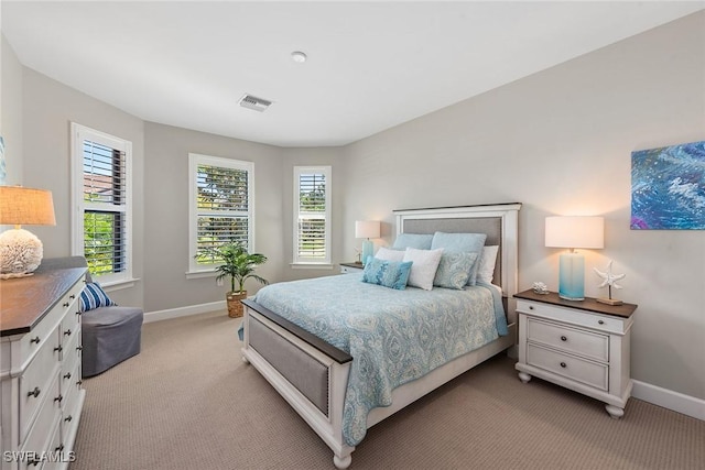 bedroom with light colored carpet, visible vents, and baseboards