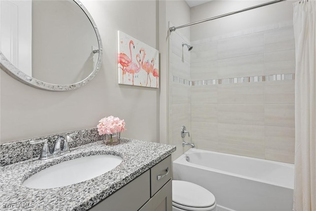 bathroom with vanity, shower / bath combination with curtain, and toilet