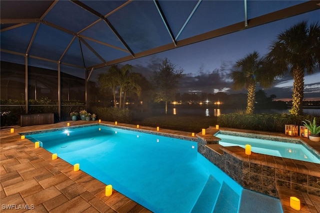 view of pool featuring glass enclosure, a patio area, and a pool with connected hot tub