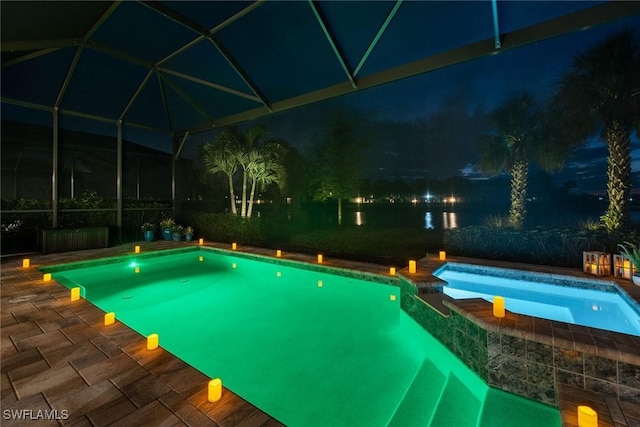 view of swimming pool featuring glass enclosure, a pool with connected hot tub, and a patio area