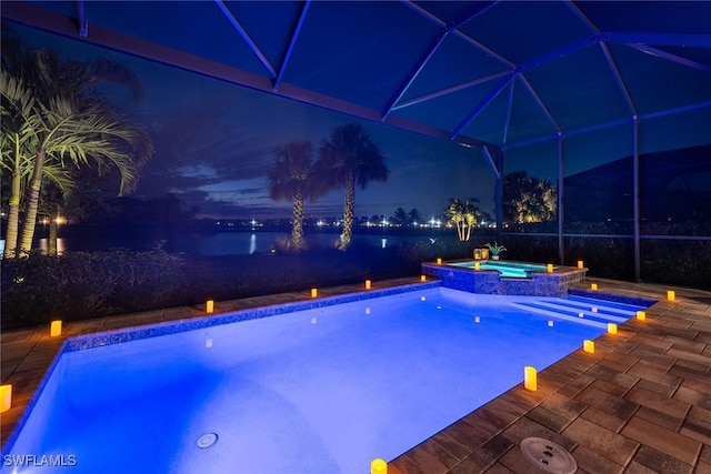 pool at twilight featuring a patio, a lanai, and a pool with connected hot tub