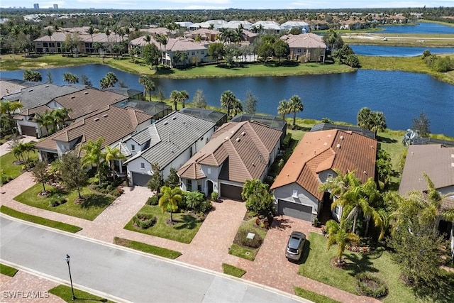 birds eye view of property with a residential view and a water view