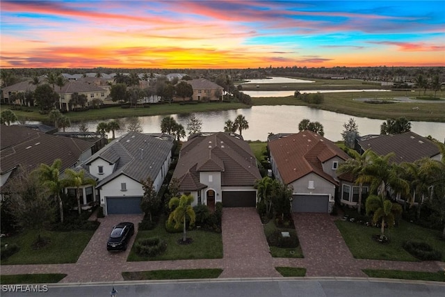 drone / aerial view with a residential view and a water view