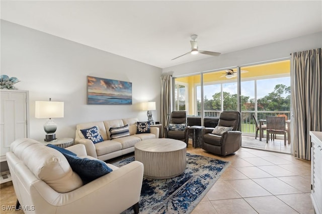 living area with light tile patterned floors and a ceiling fan