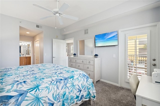 bedroom featuring baseboards, ensuite bath, visible vents, and carpet flooring