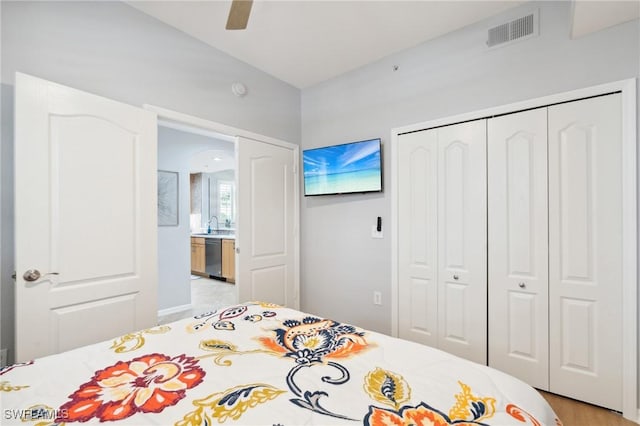 bedroom with ceiling fan, visible vents, and a closet