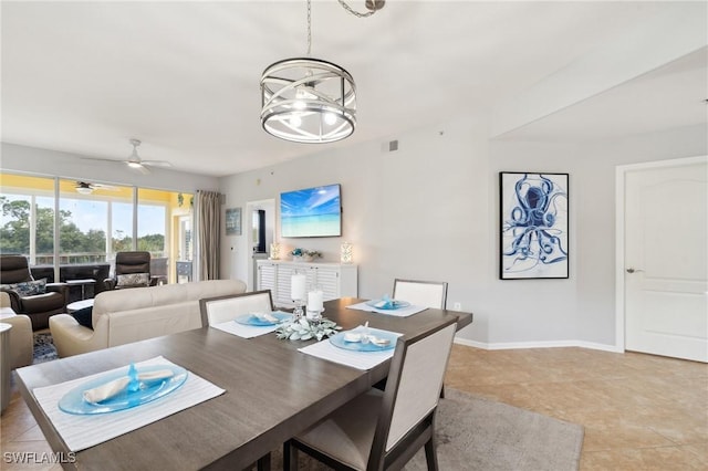 dining room with light tile patterned floors, visible vents, baseboards, and ceiling fan with notable chandelier