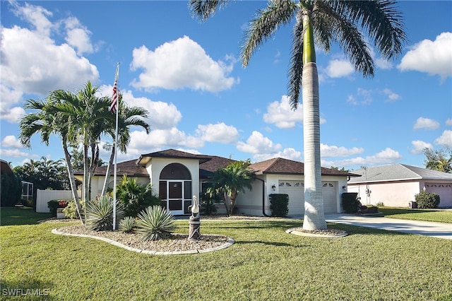 view of front facade featuring an attached garage, concrete driveway, a front yard, and stucco siding