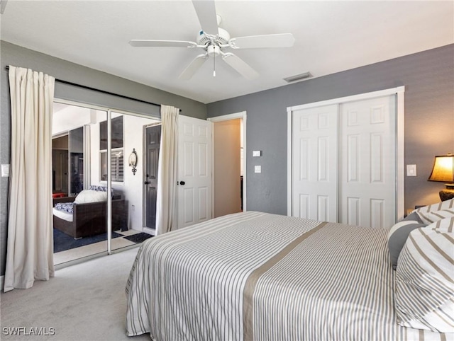 bedroom with access to exterior, a closet, visible vents, light carpet, and ceiling fan