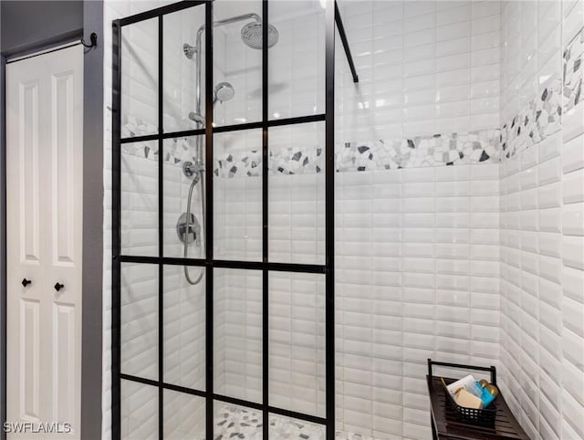 interior details featuring a tile shower