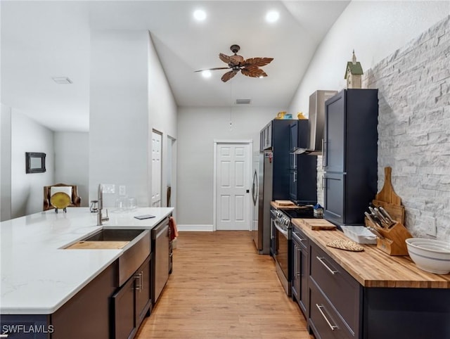 kitchen with visible vents, light wood-style flooring, appliances with stainless steel finishes, a ceiling fan, and a sink