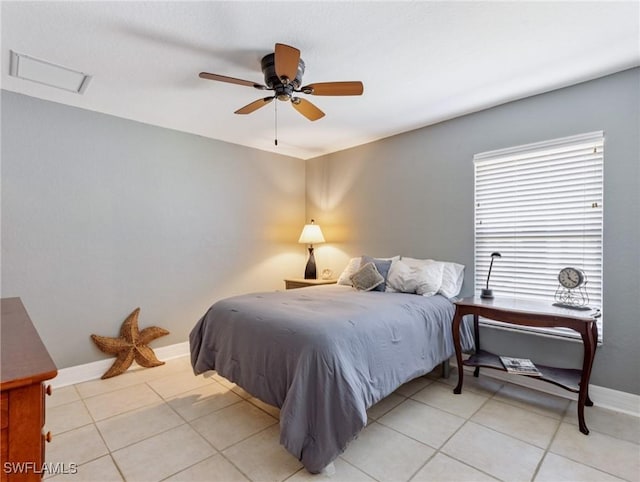 bedroom featuring light tile patterned floors, attic access, baseboards, and ceiling fan