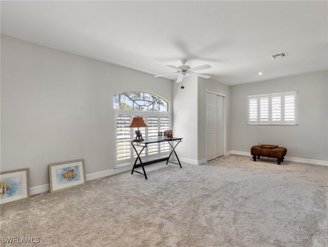 miscellaneous room featuring a ceiling fan, baseboards, visible vents, and carpet flooring