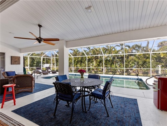 view of patio / terrace with an outdoor pool, a lanai, and ceiling fan