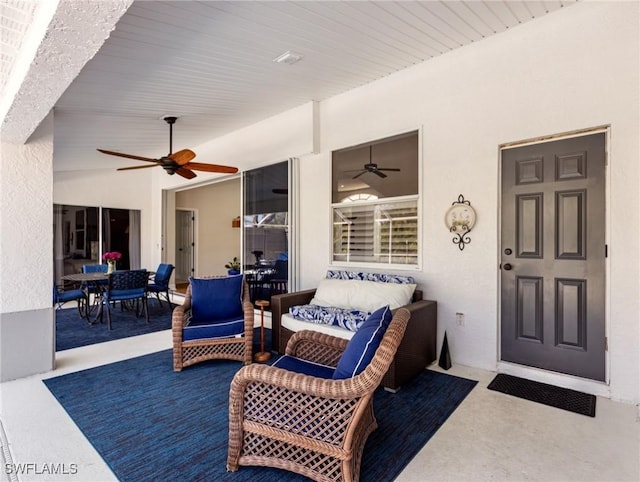 view of patio with ceiling fan, outdoor dining space, and an outdoor hangout area