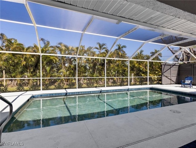 pool featuring glass enclosure and a patio