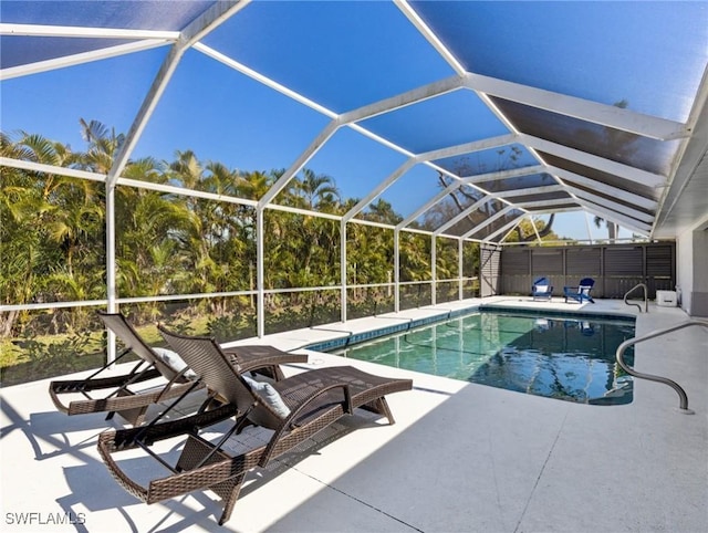 outdoor pool with a lanai and a patio area