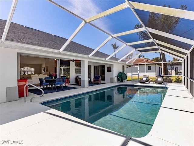 pool featuring a patio, a lanai, and a ceiling fan