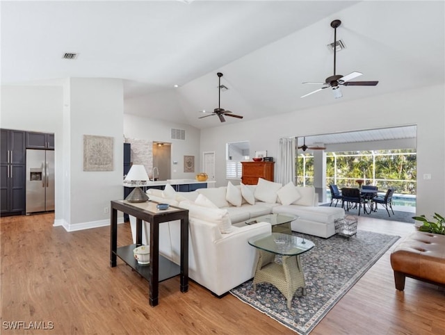 living area featuring visible vents, ceiling fan, and light wood finished floors