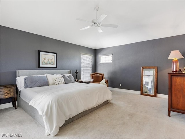 bedroom featuring light carpet, ceiling fan, vaulted ceiling, and baseboards