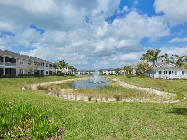 surrounding community featuring a lawn and a water view