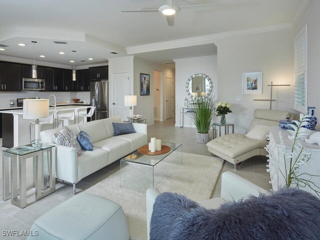 living room with ceiling fan, light tile patterned flooring, recessed lighting, and ornamental molding