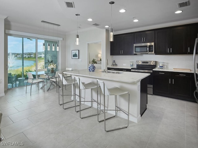 kitchen featuring a sink, stainless steel appliances, visible vents, and dark cabinets