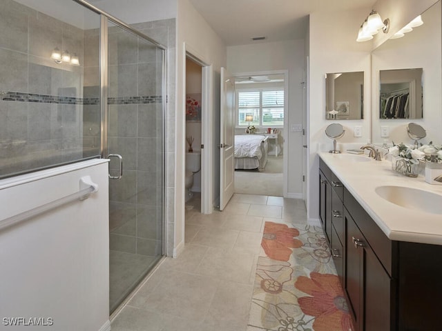 bathroom featuring a sink, a shower stall, and tile patterned floors