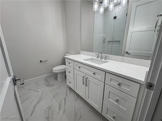 bathroom with marble finish floor, toilet, a shower stall, vanity, and baseboards