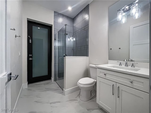 bathroom featuring toilet, vanity, baseboards, marble finish floor, and a stall shower