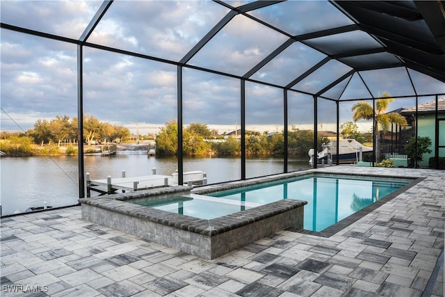 view of swimming pool with a lanai, a patio area, a water view, and a boat dock