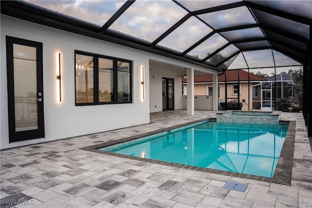 view of swimming pool with a patio and a pool with connected hot tub