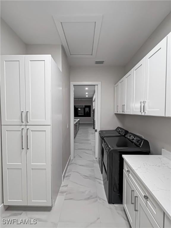 laundry area with marble finish floor, cabinet space, independent washer and dryer, and visible vents