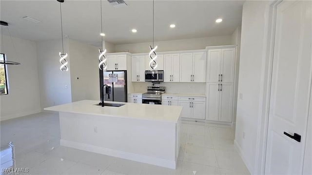 kitchen featuring a center island with sink, visible vents, white cabinets, stainless steel appliances, and a sink