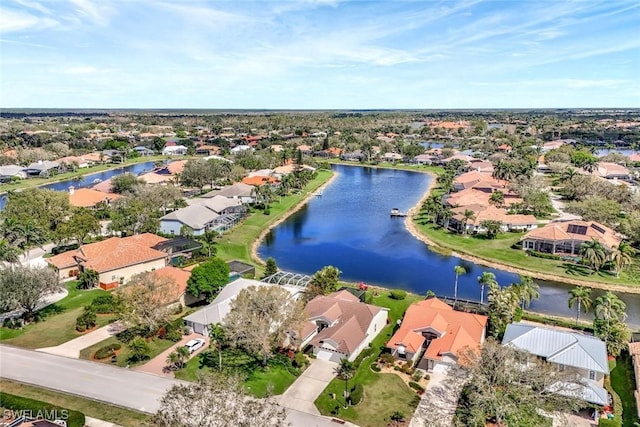 drone / aerial view featuring a water view and a residential view