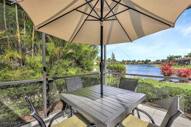 exterior space featuring outdoor dining space and a water view