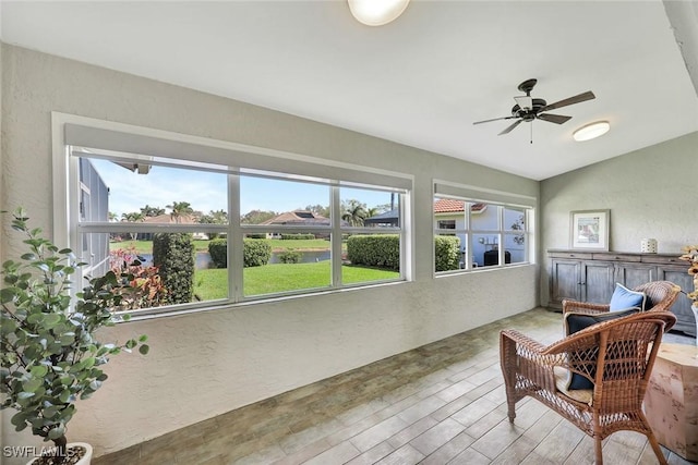 sunroom / solarium with vaulted ceiling and a ceiling fan