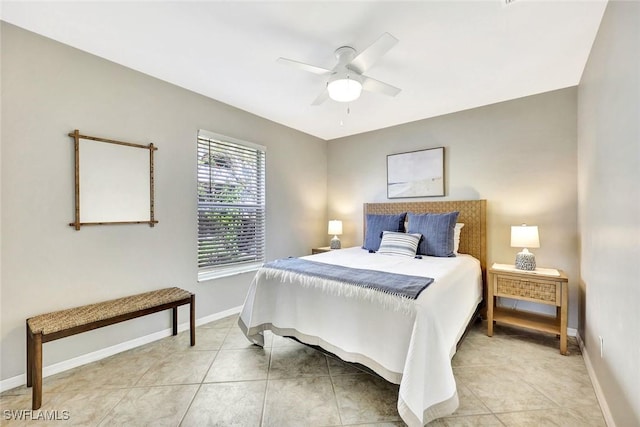 bedroom featuring light tile patterned floors, a ceiling fan, and baseboards