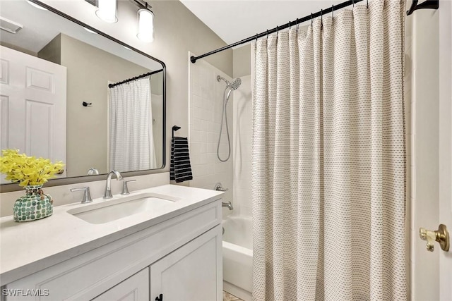 full bath with shower / bath combo, visible vents, and vanity