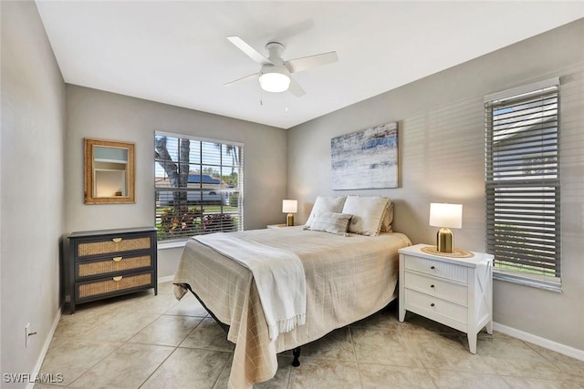 bedroom featuring light tile patterned flooring, ceiling fan, and baseboards