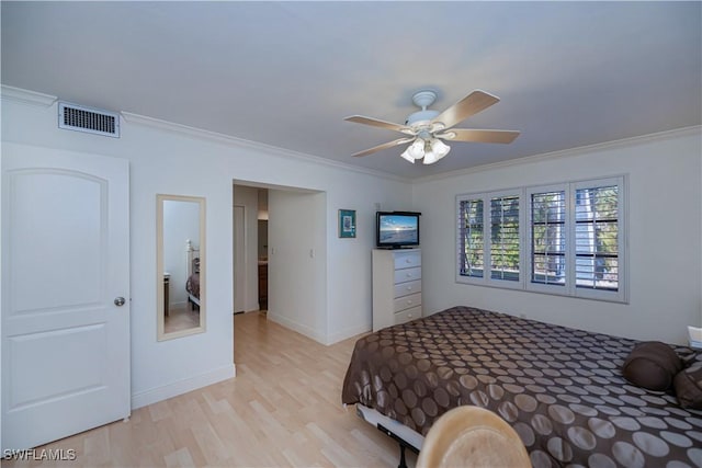 bedroom with light wood-type flooring, ornamental molding, ceiling fan, and baseboards
