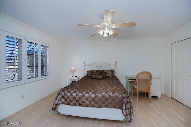 bedroom with ornamental molding, wood finished floors, baseboards, and a ceiling fan