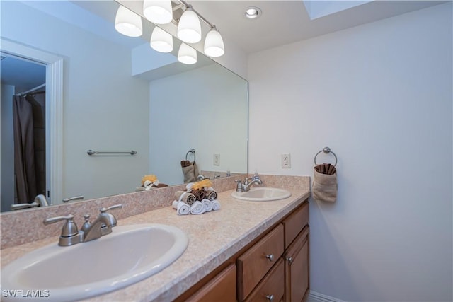 full bathroom with double vanity, a skylight, and recessed lighting