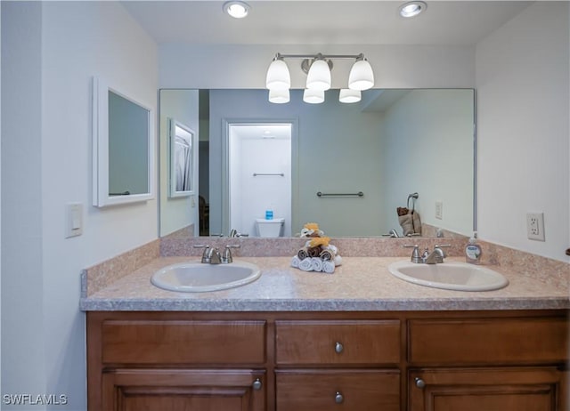 full bath featuring toilet and double vanity