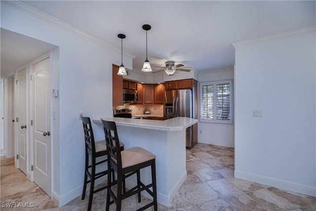 kitchen with stainless steel appliances, ceiling fan, light countertops, baseboards, and a peninsula