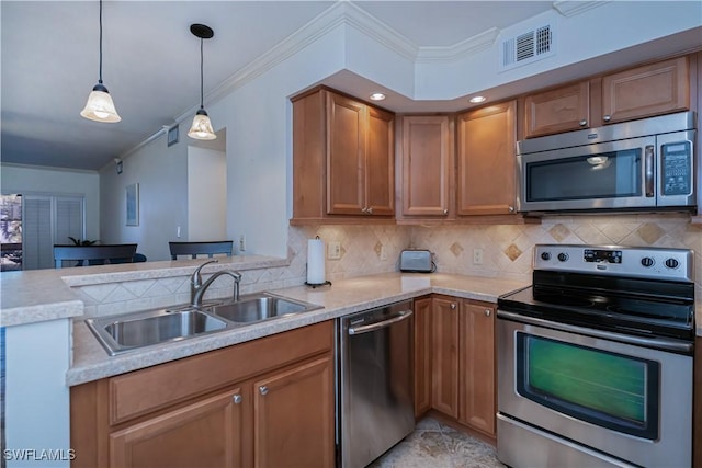kitchen with stainless steel appliances, a sink, a peninsula, ornamental molding, and light countertops