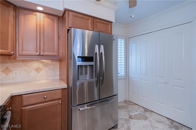 kitchen with stainless steel refrigerator with ice dispenser, backsplash, crown molding, brown cabinetry, and light countertops