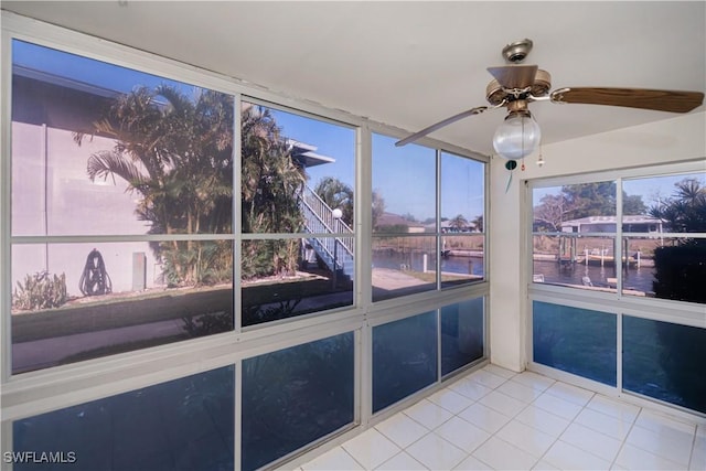 unfurnished sunroom with a water view